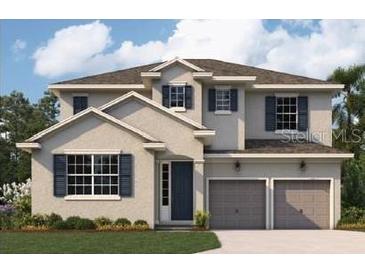 Two-story house with neutral siding, two-car garage, and landscaping at 5191 Firebrush Dr, Apopka, FL 32712