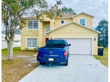 Two-story house with a two-car garage and a paved driveway at 762 Squirrel Ct, Kissimmee, FL 34759