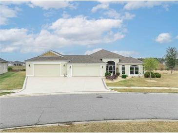 Beautiful 3-car garage home with landscaped yard at 11189 Roz Way, Oxford, FL 34484