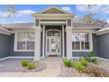 Gray house exterior with white columns and landscaping at 5055 County Road 125 # B1, Wildwood, FL 34785