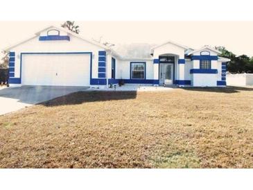 Beautiful two-story home with a two-car garage and well-manicured lawn at 7558 Sw 103Rd Loop, Ocala, FL 34476