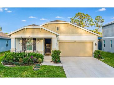 Charming single-story home with a two-car garage, well-maintained landscaping, and a welcoming front porch at 10161 Spring Lake Dr, Clermont, FL 34711