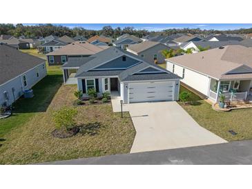 Well-manicured lawn and neutral tones highlight this charming single-story home with a two car garage at 4654 Ramsell Rd, The Villages, FL 32163