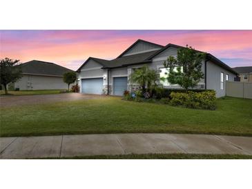 Beautiful home with two-car garage and landscaped lawn at 729 Calabria Way, Howey In The Hills, FL 34737