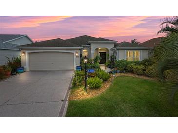 Attractive single-story home with landscaped yard and two-car garage at 848 Folsum Pl, The Villages, FL 32162