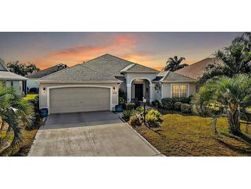 Attractive single-story home with a landscaped lawn and attached garage at 848 Folsum Pl, The Villages, FL 32162