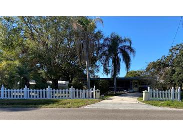 Cute ranch home with white picket fence and palm trees at 1220 Beulah Rd, Winter Garden, FL 34787