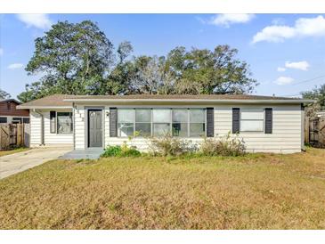 One-story house with a large front yard and driveway at 1412 N Garfield Ave, Deland, FL 32724