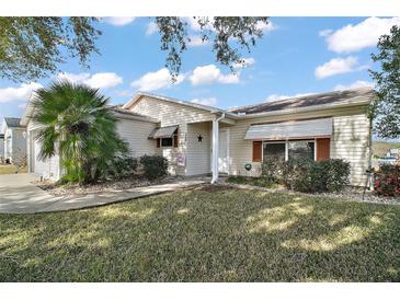 Cute one-story home with landscaped lawn and walkway at 2001 Cristo Rd, Lady Lake, FL 32159