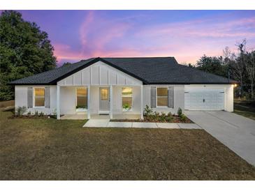 Charming single-story house with gray roof and white exterior at 51 Aspen Rd, Ocala, FL 34480