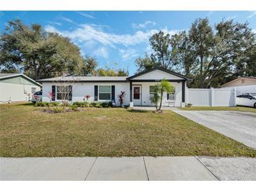 Charming ranch home with white exterior, landscaping, and driveway at 1301 Sand Pine Ave, Ocoee, FL 34761