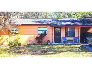 Charming single-story home with a well-maintained lawn and covered porch at 15906 Douglas Rd, Mascotte, FL 34753