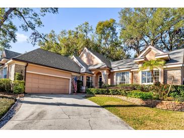 Beautiful home with landscaping, driveway and two-car garage at 2043 Sawgrass Dr, Apopka, FL 32712