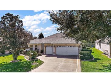 Attractive single-story home with a two-car garage and well-manicured lawn at 526 Kingston Way, The Villages, FL 32162