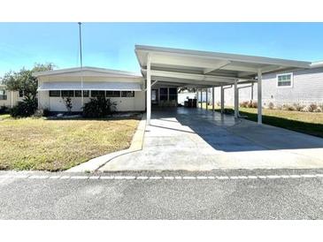 Charming single-story home featuring a spacious carport and well-maintained front lawn at 149 Royal Palm Dr, Leesburg, FL 34748