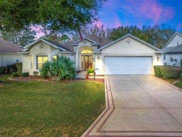 Charming single-story home featuring a well-manicured lawn and a two-car garage at 16814 Se 80Th Bellavista Cir, The Villages, FL 32162