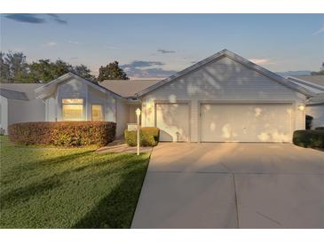Two-car garage with a well-lit front yard at 2507 Caribe Dr, The Villages, FL 32162