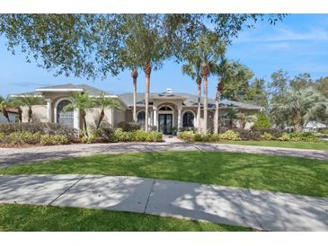 Elegant home featuring well manicured landscaping, a circular driveway and a welcoming entrance at 1029 Juliette Blvd, Mount Dora, FL 32757