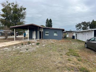 Ranch style home with carport and mature trees at 1121 Oakland Dr, Tavares, FL 32778