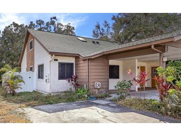 Updated two-bedroom, one-bath home with covered carport and mature landscaping at 1313 Vine St, Leesburg, FL 34748