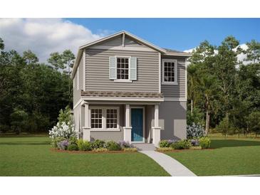 Two-story craftsman style home with gray siding, blue door, and landscaped lawn at 16908 Hamlin Oasis Loop, Winter Garden, FL 34787