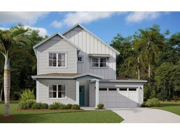 Two-story home with light gray siding, teal door, and attached garage at 3083 Prospect Trl, St Cloud, FL 34771