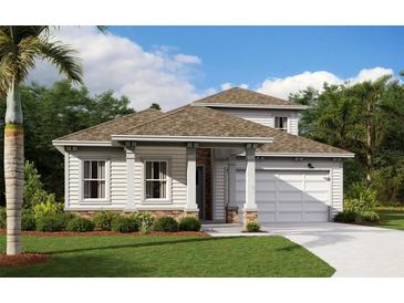Charming one-story home with covered porch, attached garage, well-maintained lawn, and lush landscaping at 3083 Prospect Trl, St Cloud, FL 34771