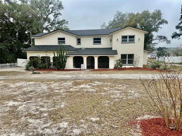 Two-story house with a large front yard and attached garage at 4520 N Hiawassee Rd, Orlando, FL 32818