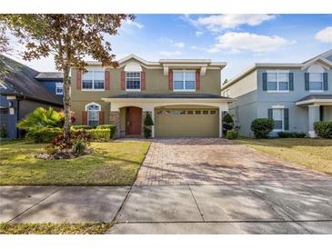 Two-story house with a two-car garage and landscaped front yard at 10962 Willow Ridge Loop, Orlando, FL 32825