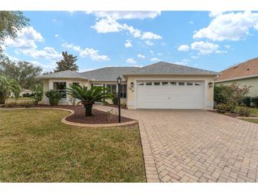 Single-story home with a paved driveway and landscaped lawn at 1514 Vandam St, The Villages, FL 32162