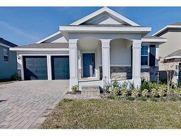 Two-story home with two-car garage and landscaped front yard at 2113 Axel St, Minneola, FL 34715