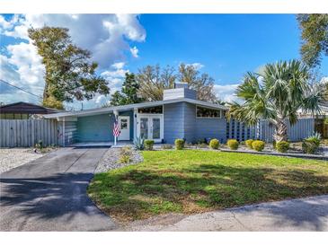 Charming single story home featuring a well-maintained lawn, carport, and elegant landscaping at 2384 Orange Capital Ct, Eustis, FL 32726