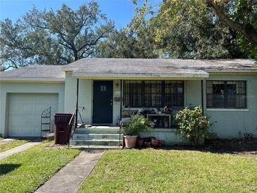 Charming single-story home with a welcoming front porch and a well-maintained lawn at 3100 Oberlin Ave, Orlando, FL 32804