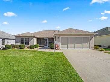 Charming single-story home with a well-manicured lawn and neutral exterior at 3183 Hatch Ln, The Villages, FL 32162