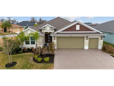 House front with landscaping and three-car garage at 3769 Causey Ct, The Villages, FL 32163