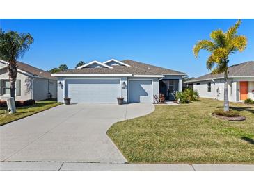 Single-story home with two-car garage and landscaped lawn at 4127 Arlington Ridge Blvd, Leesburg, FL 34748