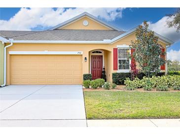 Charming home with a well-manicured front yard, two-car garage, and neutral color scheme at 752 Chacall Loop, Mount Dora, FL 32757