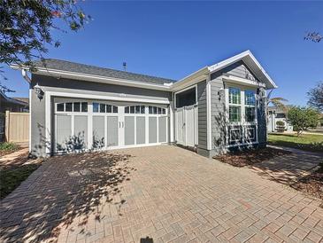 Charming single-Gathering home featuring a two-car garage and a brick driveway at 113 Bayou Bend Rd, Groveland, FL 34736