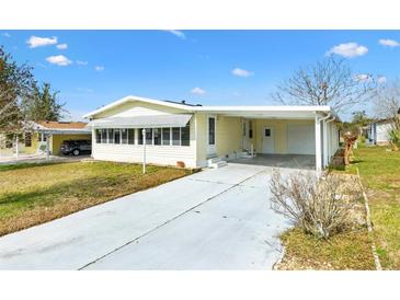 Charming single-story home with a covered carport and well-maintained lawn, offering comfort and convenience at 1616 Bayhill Dr, The Villages, FL 32159