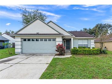 One-story house with attached garage, well-manicured lawn, and attractive landscaping at 167 N Cervidae Dr, Apopka, FL 32703