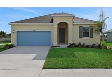 Charming single-story home with a well-manicured lawn, blue garage door and neutral paint scheme at 2854 Supermarine Rd, Tavares, FL 32778