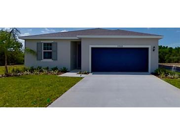 Charming single-story home with a well-manicured lawn and a two-car garage at 2968 Supermarine Rd, Tavares, FL 32778