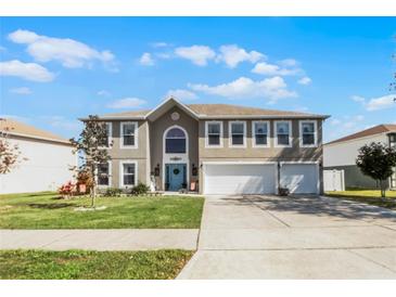 Charming two-story home with well-maintained lawn, three-car garage, and inviting curb appeal at 3215 Park Branch Ave, Clermont, FL 34711