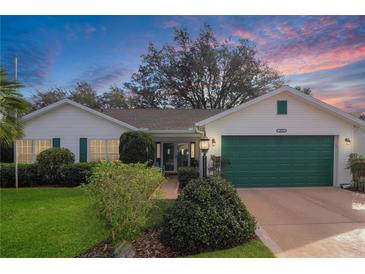 Charming single-story home featuring a well-maintained lawn and attached two-car garage at 4034 River Crest Cir, Leesburg, FL 34748