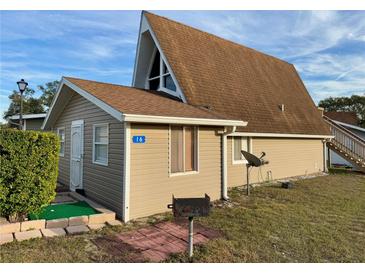 Unique exterior featuring a brown roof, light tan siding, and well-maintained landscaping creates a welcoming and distinctive curb appeal at 10301 Us Highway 27 # 16, Clermont, FL 34711