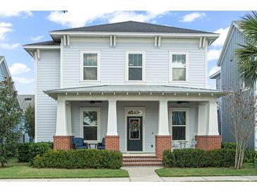 Charming two-story home with a covered front porch and manicured landscaping creating a welcoming curb appeal at 1041 Linehart Dr, Winter Garden, FL 34787