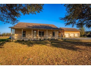 Charming single story home with a covered porch and detached garage at 11325 Michael John Rd, Howey In The Hills, FL 34737