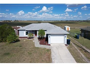 Charming single-story home with a well-maintained yard, driveway, and two-car garage at 119 Cory Ct, Auburndale, FL 33823