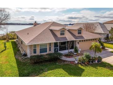 Charming single-Gathering home featuring well-kept landscaping and a cozy, inviting front entrance at 1739 Lake Villa Dr, Tavares, FL 32778