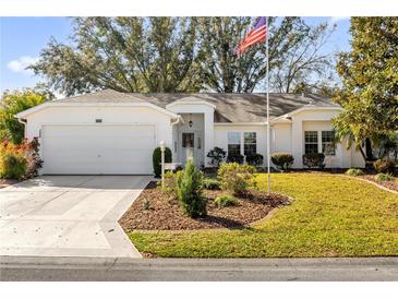 Charming single-story home with well-manicured front yard and attached two-car garage at 5428 Tangelo St, Leesburg, FL 34748